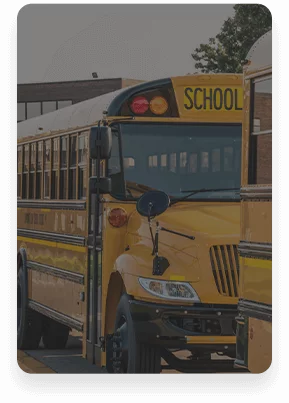 Two school buses in front of a school